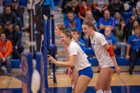 Annie Kaminski enjoying herself, smiling as she  waits for the serve during the New Mexico home match in Bronco Gym in 2023.