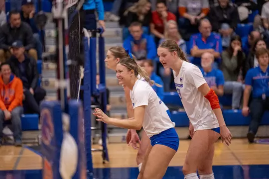 Annie Kaminski enjoying herself, smiling as she waits for the serve during the New Mexico home match in Bronco Gym in 2023.
