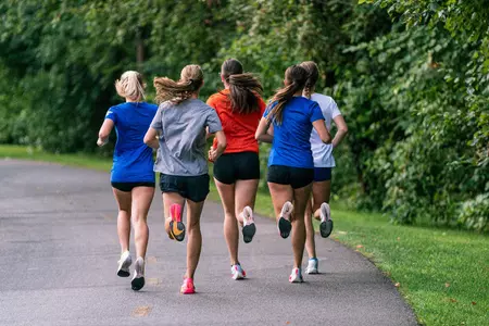 Five members of the women's cross country team running