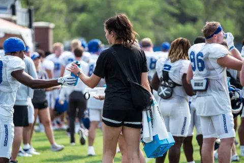 A look at some of the football support staff members working during a fall camp practice. Photo by Kenna Harbison