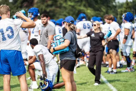 A look at some of the football support staff members working during a fall camp practice. Photo by Kenna Harbison
