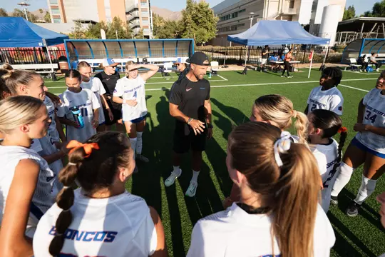 Coach Thomas in team huddle at UC Riverside