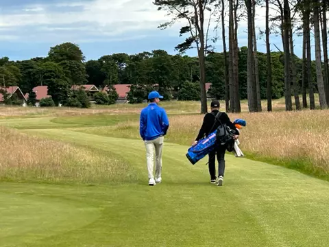 Cole Rueck walks with his dad, Scott, at the Scottish Open