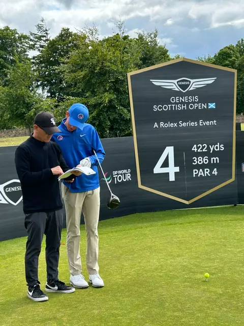 Cole Rueck and his dad, Scott, consult a yardage book at the Scottish Open.