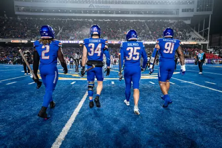 Boise State football captains Ashton Jeanty (2), Alexander Teubner (34), Jonah Dalmas (35) and Ahmed Hassanein (91) walking on field for coin toss
