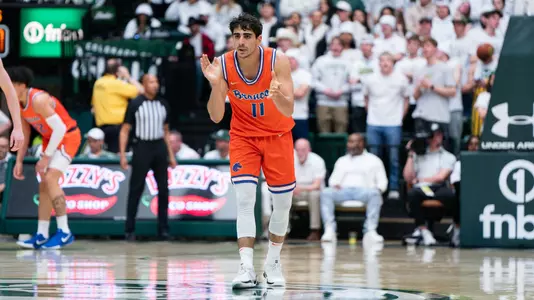 Alvaro Cardenas claps hands while getting back on defense