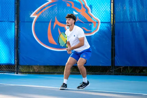 Carson Baker with two hands on his racket
