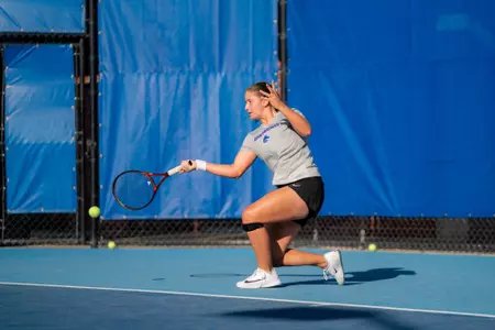 Carla Grignac hitting a forehand shot close to the ground