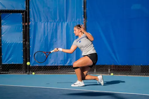 Carla Grignac hitting a forehand shot close to the ground