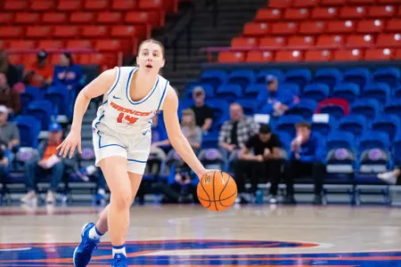 Mya Hansen dribbles the ball to her left.