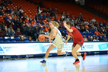 Tatum Thompson dribbles past a defender.