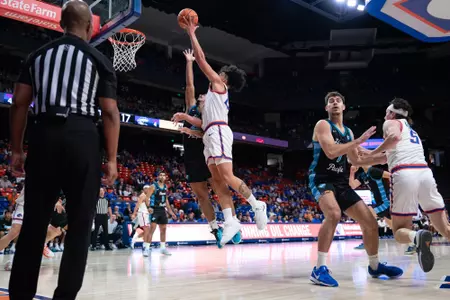 Javan Buchanan attempts a hook shot in the team's season opener against Hawai'i Pacific at ExtraMile Arena