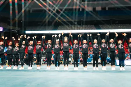 Boise State gymnastics team waving to crowd after a home meet