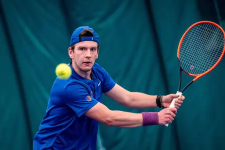 Julius Seifert stares at the ball as he prepares to hit it with a backhand swing during the Michigan State match on Feb. 9, 2025.