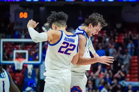 Javan Buchanan & Tyson Degenhart jump in the air and celebrate with a shoulder bump against New Mexico