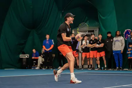 Jett Middleton celebrates a point against Indiana on Feb. 19 by clutching his fist and raising his racquet.