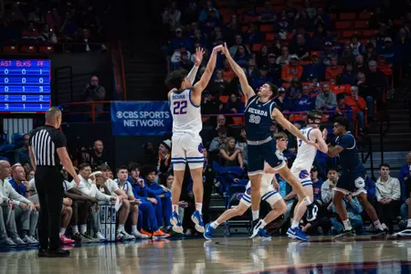 Javan Buchanan attempts a three-pointer on the left wing against Nevada