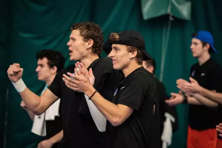Adam Duda and Michael Seversen their teammates on during the Indiana match, Feb. 19, 2025