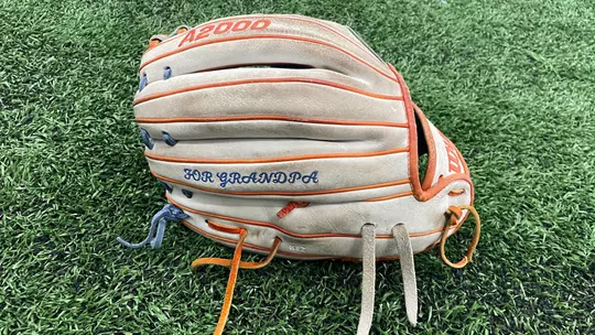 Mykenzie Hanna's glove on turf.