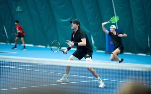 Jett Middleton playing doubles and waiting at the net for a return shot during the Eastern Washington match on January 31, 2025.