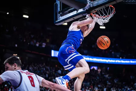 Andrew Meadow dunks the basketball late in the game against New Mexico