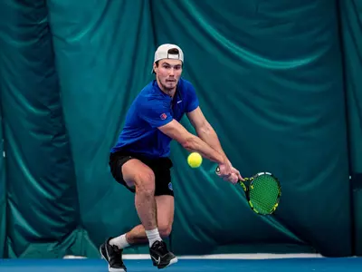 Carson Baker returns a backhand shot during the match against Michigan State in February of 2025.