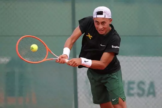 John Chin using his backhand to return a shot during a Davis Cup match.