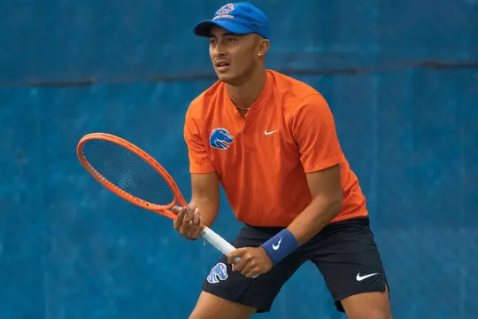 John Chin wearing orange jersey waiting to receive a serve during the 2023 Montana match in Boise.