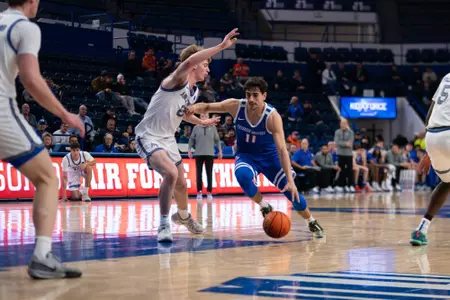 Alvaro Cardenas dribbles and attacks the paint against Air Force