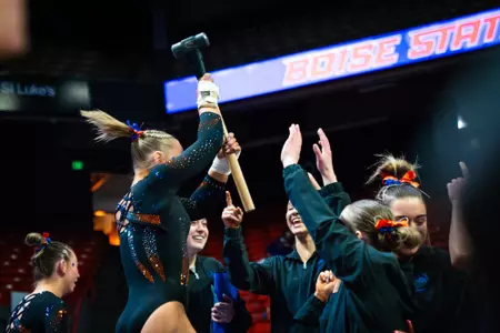 Julia Krzywanski celebrating with the hammer and her team.