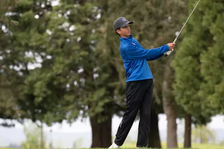 Cole Rueck takes a swing on a golf course
