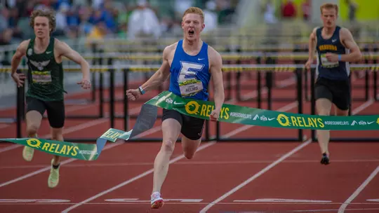 Landon Helms winning a race at the Oregon Relays in high school