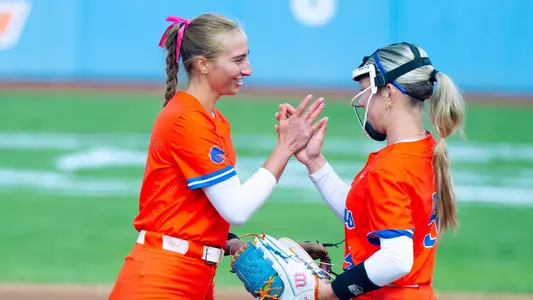 Hollie Farmer and Olivia Bauer exchange a high five in the circle.