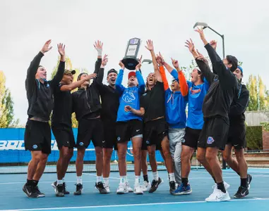 Men's Tennis celebrates with trophy for the 2025 MW Regular Season Championship.