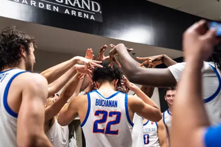 Javan Buchanan being crowned by his team in the locker room.
