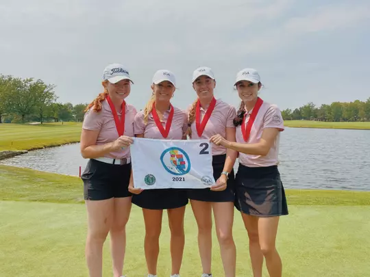 Carly Carter, Emily Cadwell, Kelli Ann Strand and Brooke Patterson holding flag after finishing second at America's Cup