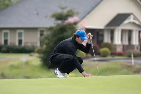 Luke Cushman places the ball on a green