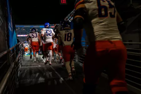 Boise State football players running out of the tunnel before the 2024 Vrbo Fiesta Bowl