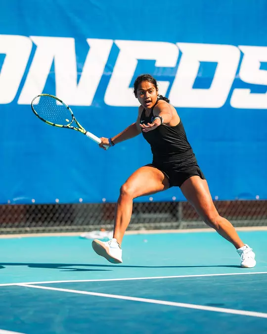 Bhakti Shah races to return a forehand shot during the Utah State match in 2025.