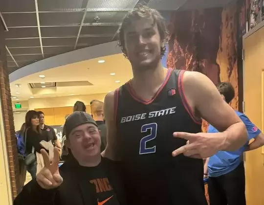 Tyson Degenhart poses with DJ, a Boise State super fan