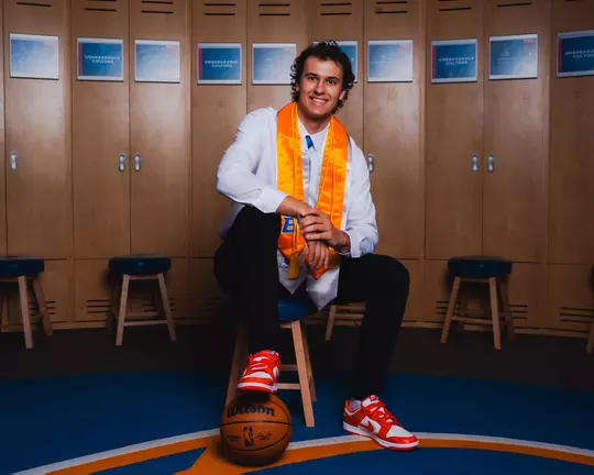 Tyson Degenhart poses in men's basketball locker room