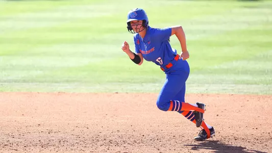 Megan Lake running from second to third base.