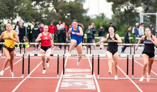 Maggie Shirazi running close to a hurdle
