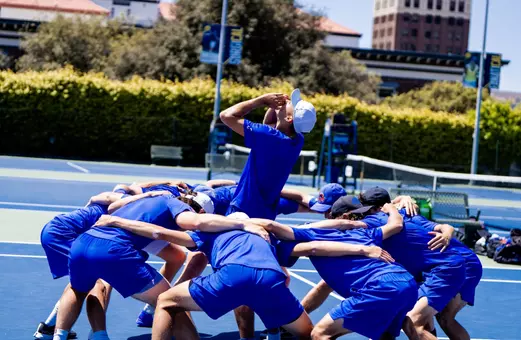 Men's Tennis prematch huddle at NCAA Tournament vs California in 2025.
