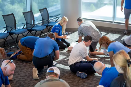 A group of Boise State athletics staff learning CPR