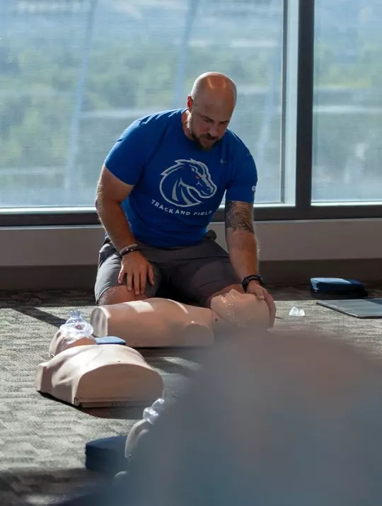 Tyler Smith preparing to demonstrate CPR on a dummy