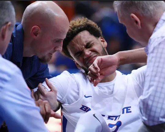 Tyler Smith helping an injured James Webb