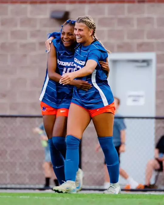 Asia Lawyer and Kenzie MacMillan, wearing blue jerseys, celebrate first goal of 2025 at Idaho State.