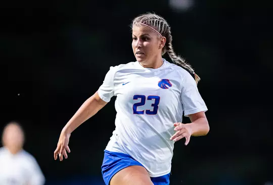 Kenzie MacMillan, wearing a white jersey, running looking for the pass.