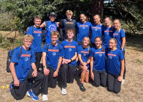 Team shot, wearing blue, cross country team poses at Lewis & Clark Opener